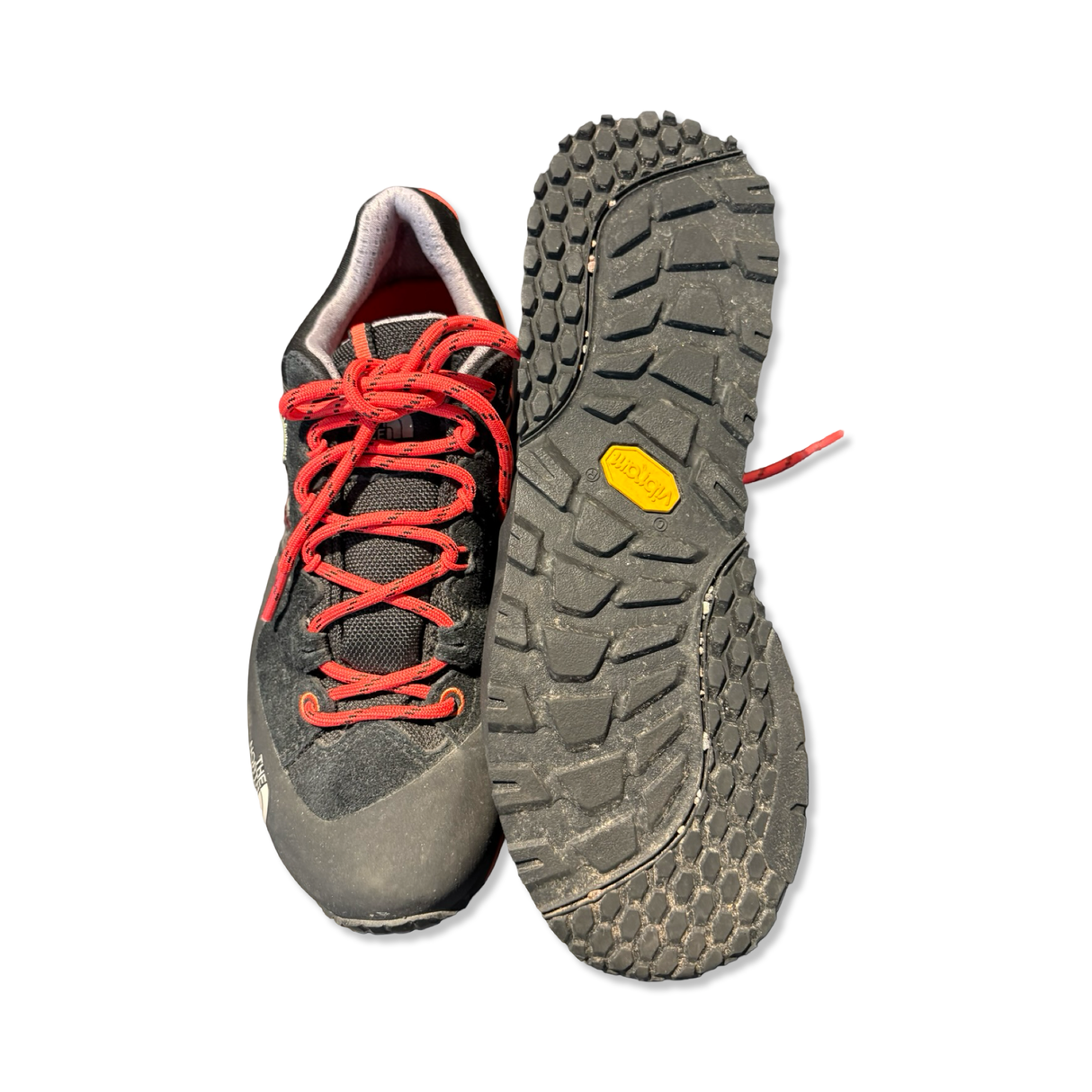 Black and red The North Face Verto Plasma II women's hiking shoes showing upper and lugged outsole, against a white background.