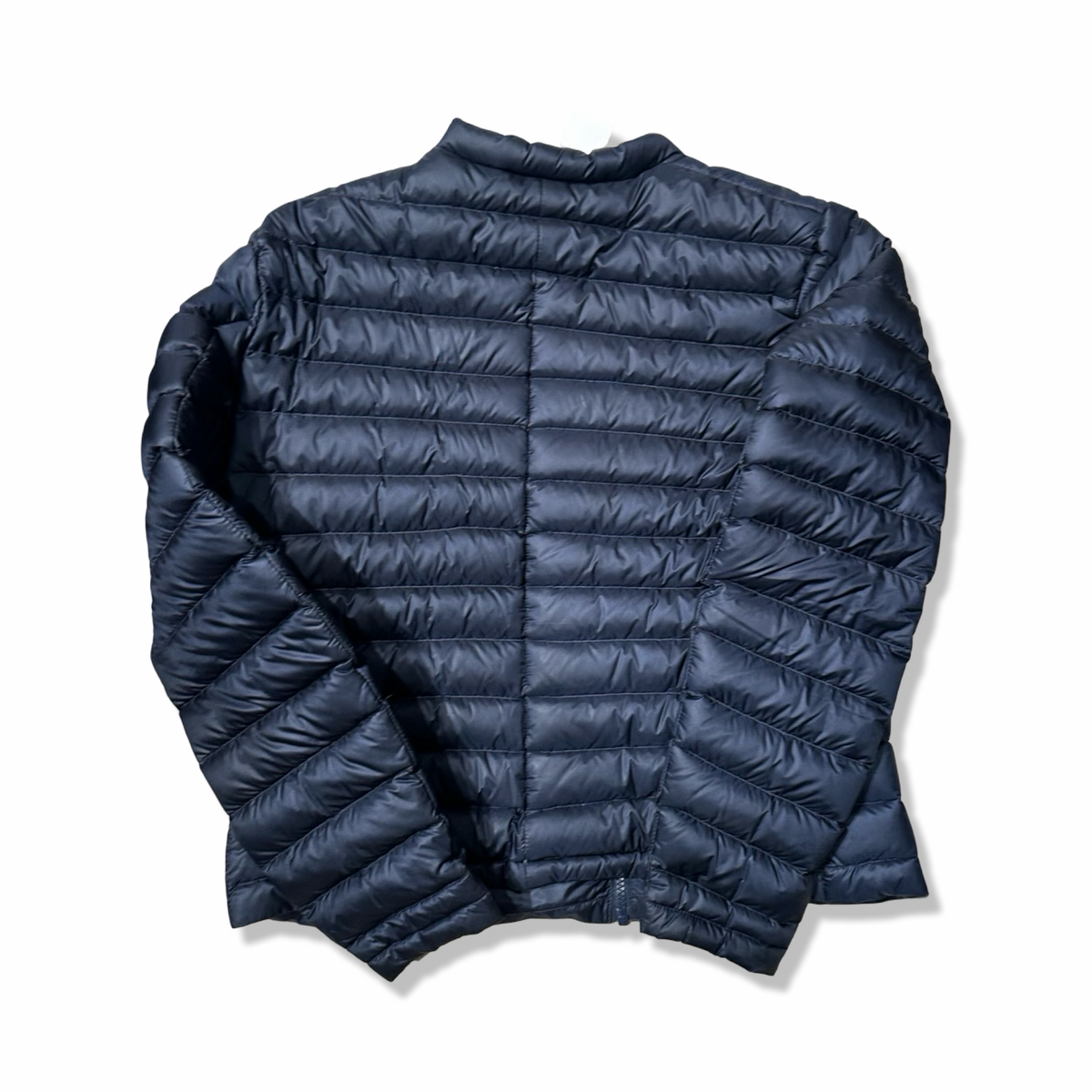 Back view of a blue Peak Performance women's down jacket against a white background.
