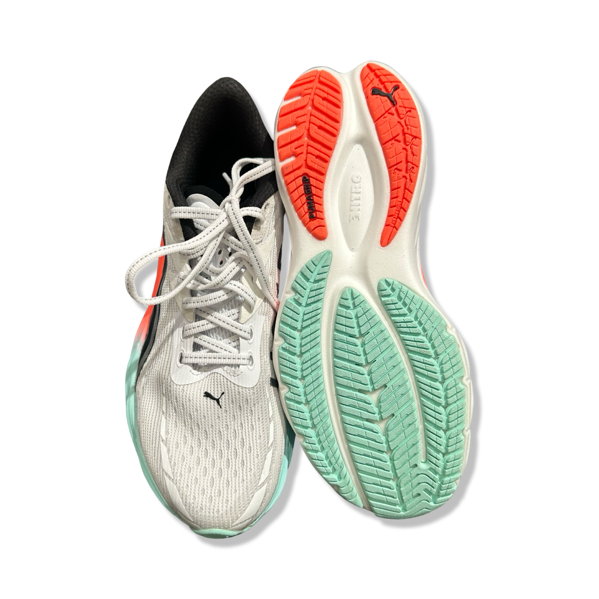 A pair of white Puma Velocity Nitro 4 HYDROX women's running shoes, viewed from above with one sole facing upward against a white background.