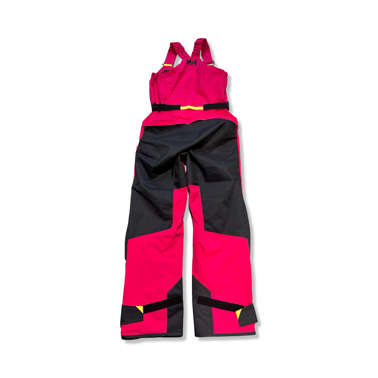 Rosa och svarta Helly Hansen W Skagen Offshore Bib seglarbyxor för dam, fotograferade bakifrån mot vit bakgrund.