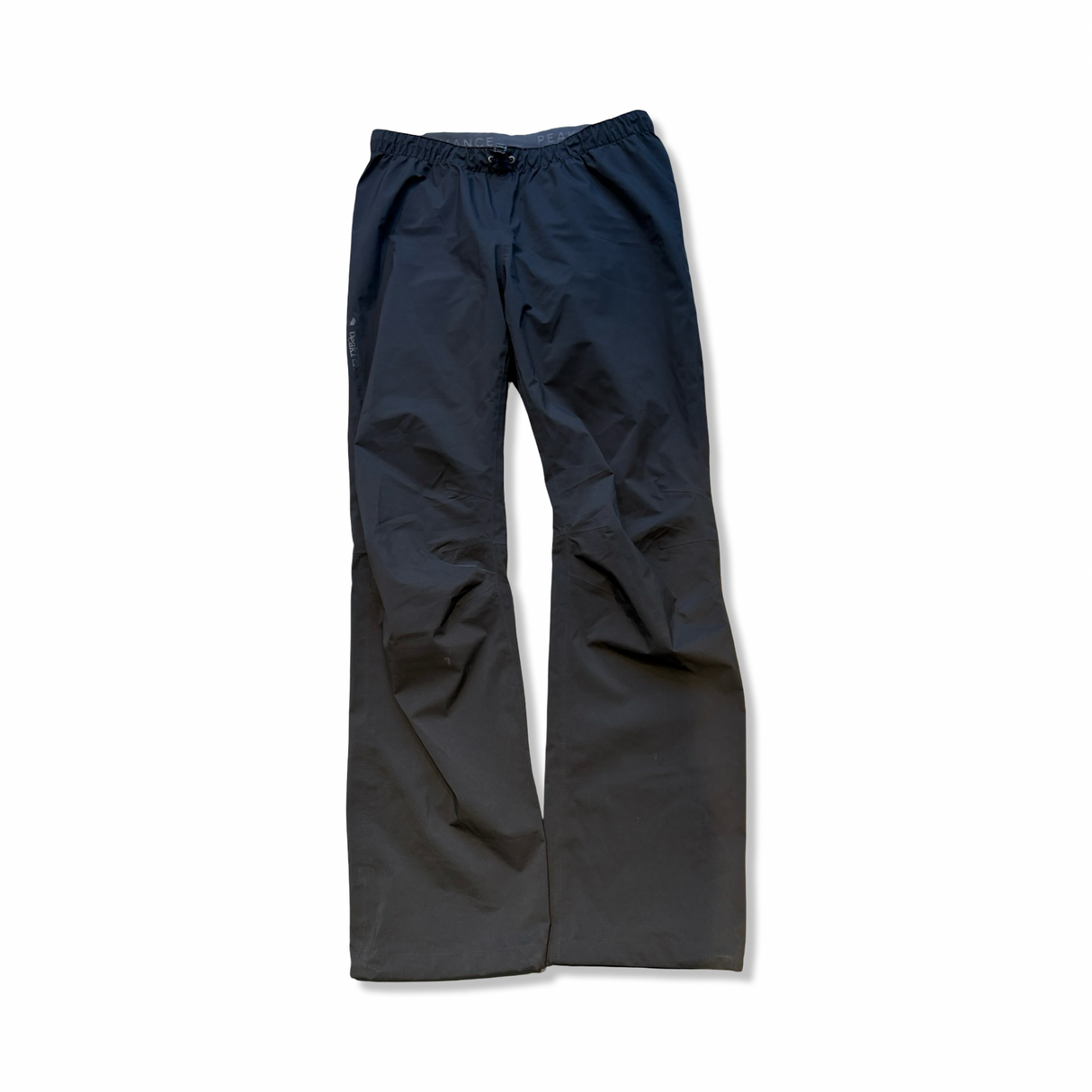 Black rain pants from Peak Performance in a thin shell model for women, photographed from directly above against a white background.