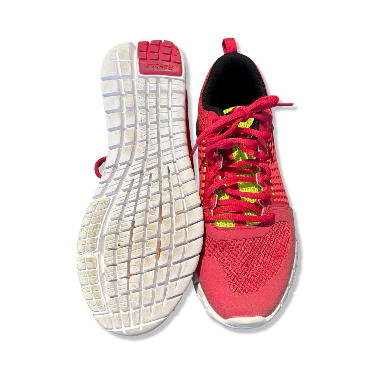 Pink women's Reebok Nanoweb running shoes with visible sole, photographed from the front and underneath against a white background.