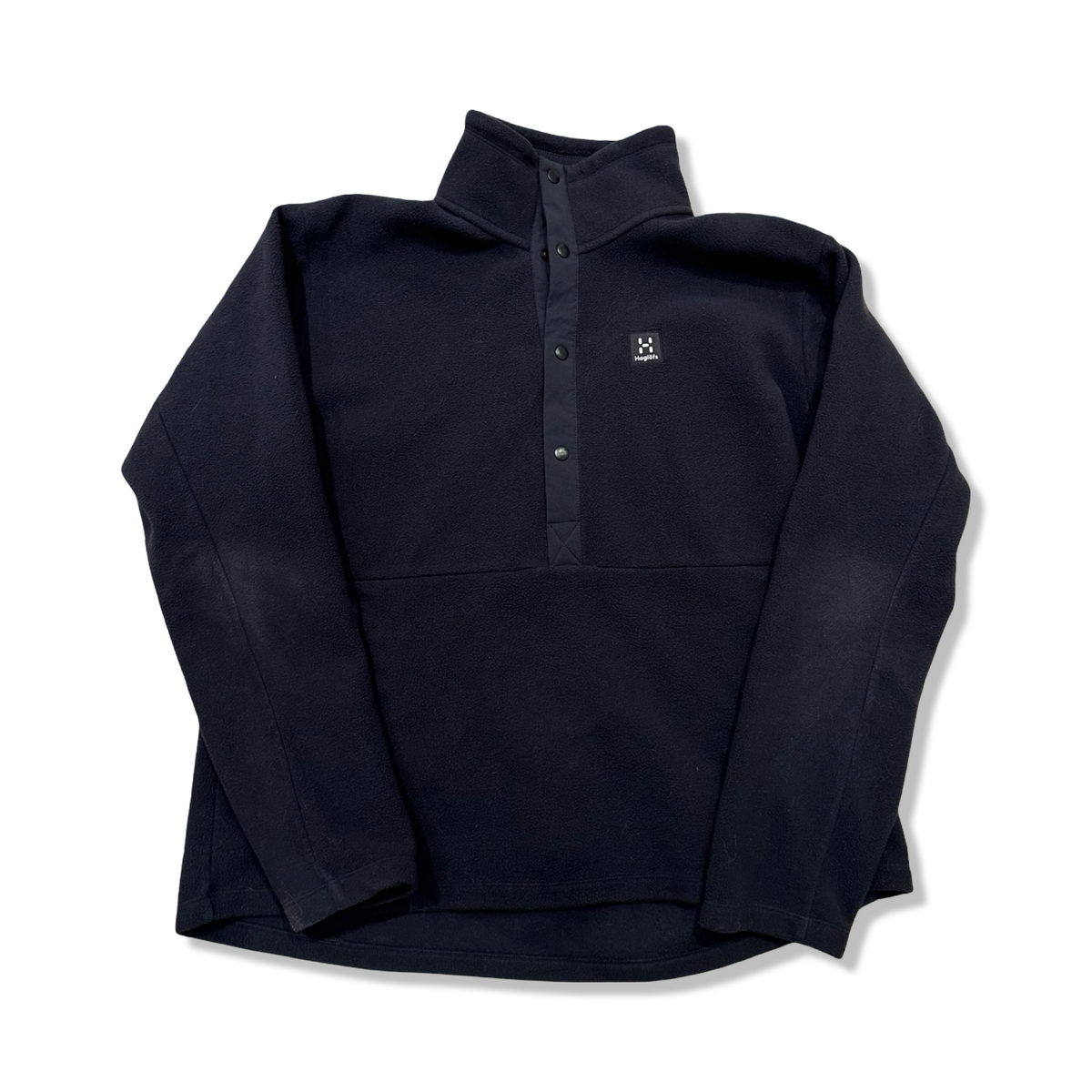 Black Haglöfs Mora mid women's fleece sweater with snap buttons, front view against a white background.