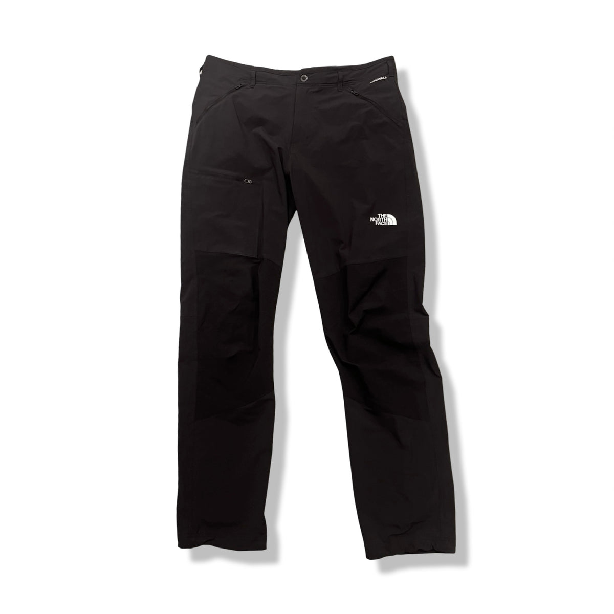 Black The North Face men's softshell trousers with zippered pockets, front view against a white background.