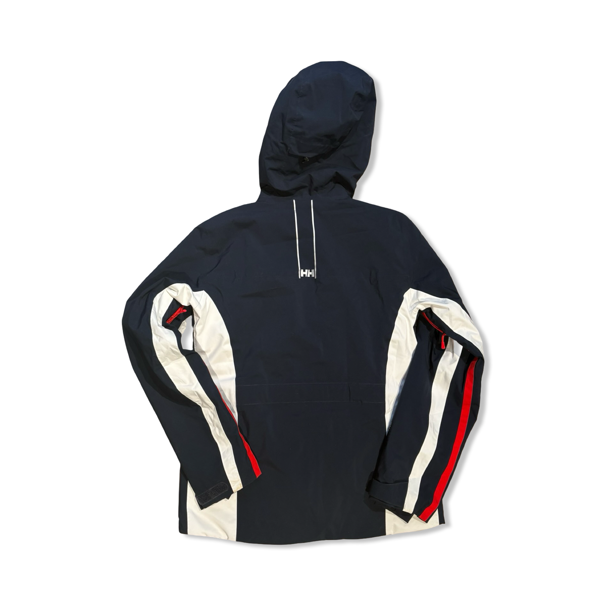 Back view of a dark blue and white Helly Hansen women's hooded ski jacket against a white background.