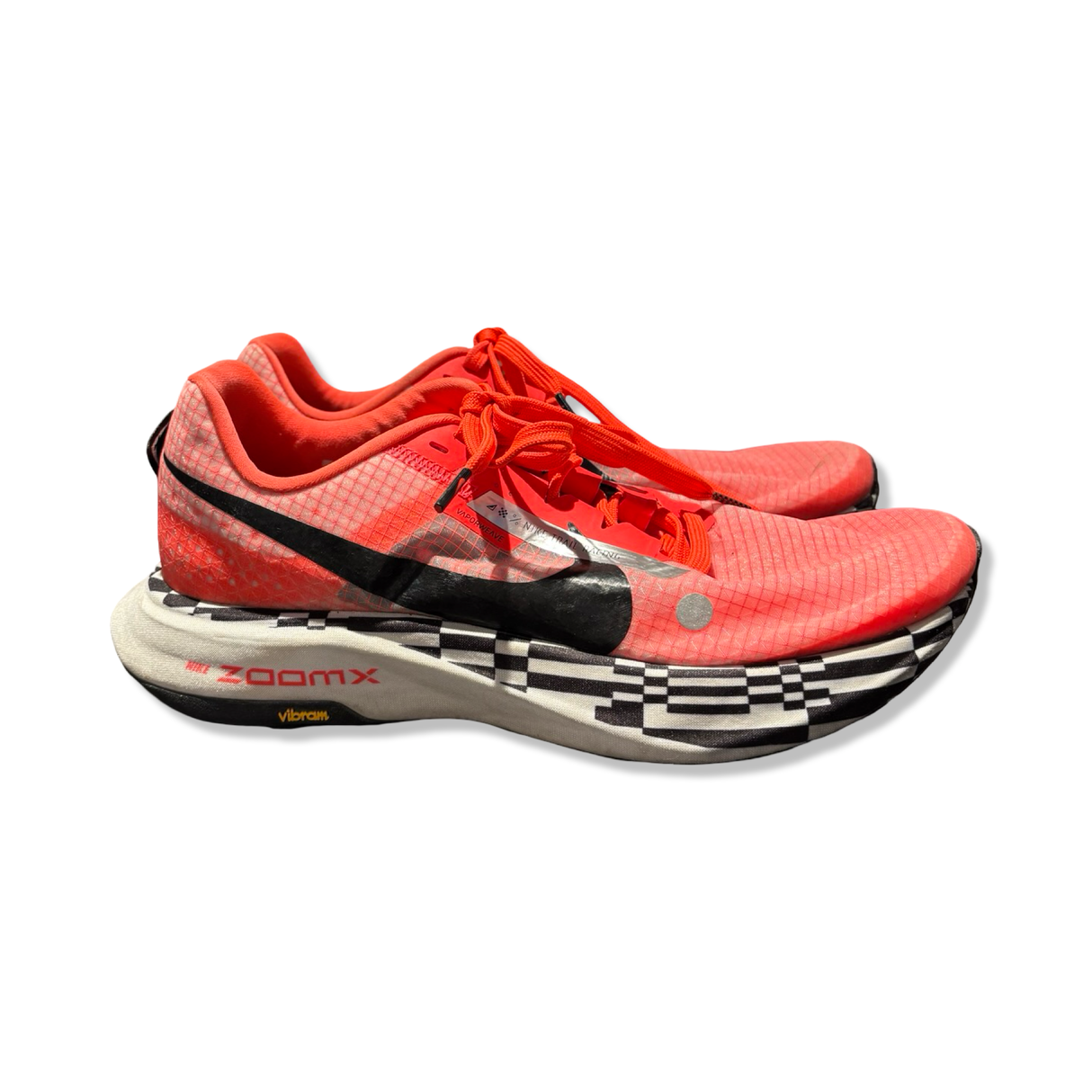 Orange and black patterned Nike ZoomX Ultrafly Trail unisex running shoes with a thick sole, photographed from the side against a white background.