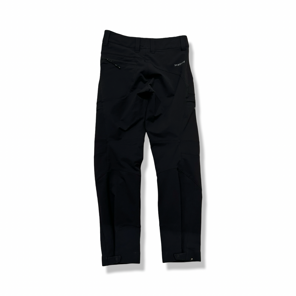 Back view of a pair of black Norröna svalbard flex pants for women against a white background.