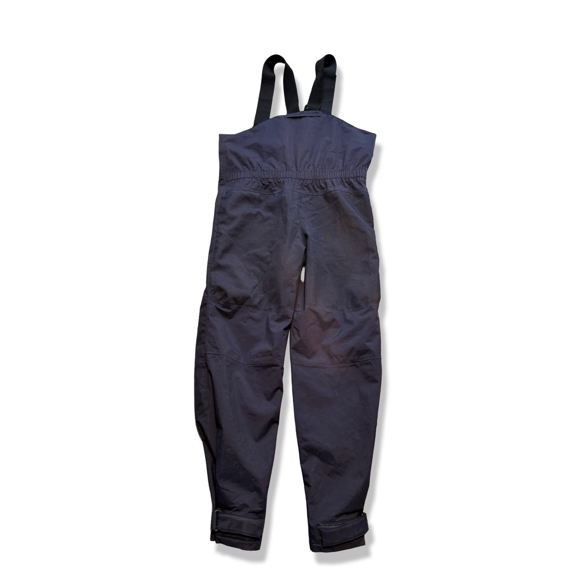 Navy blue Gill men's sailing trousers with suspenders and reinforced knees and seat against a white background.