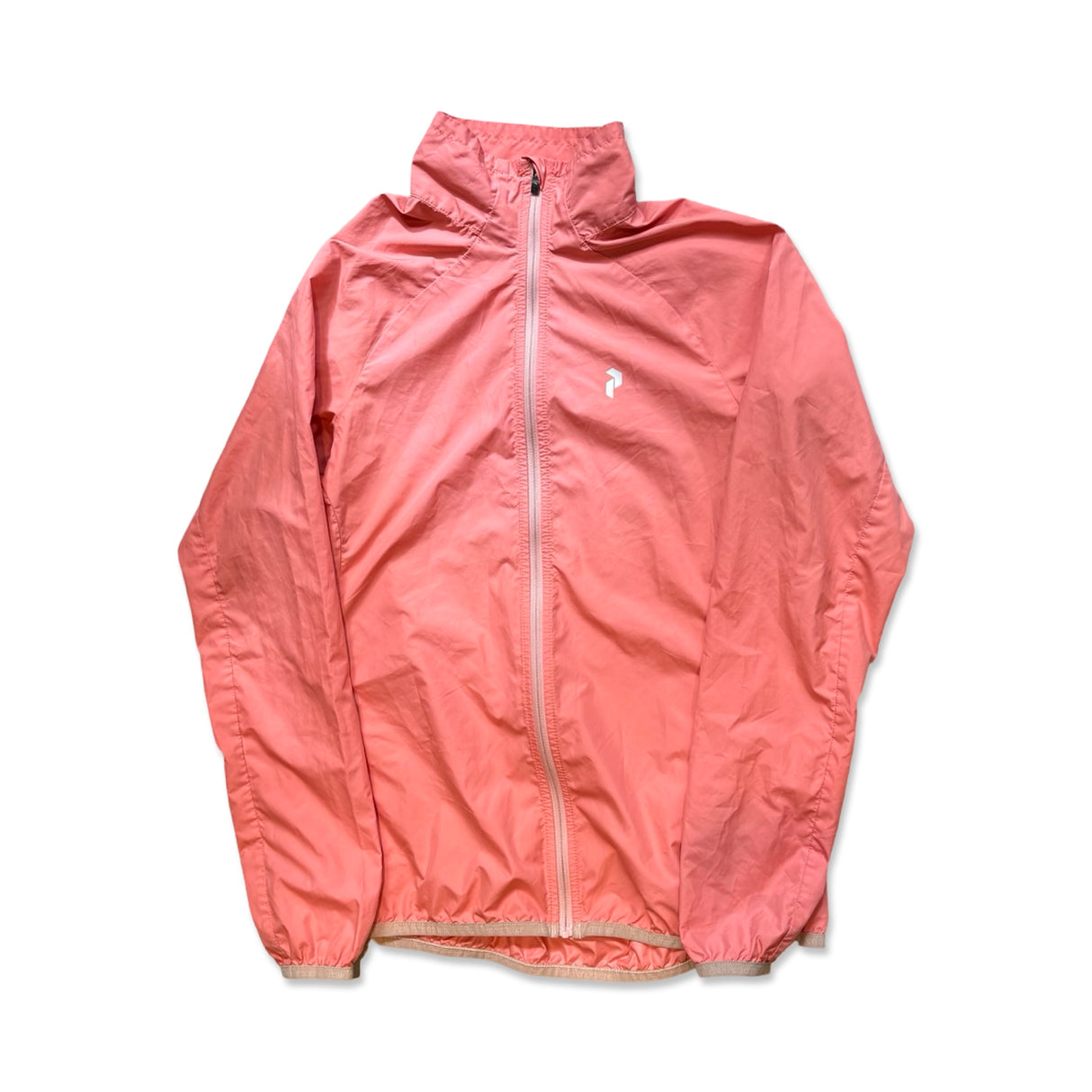 Apricot Peak Performance women's training jacket with a high collar and full zipper on a white background.