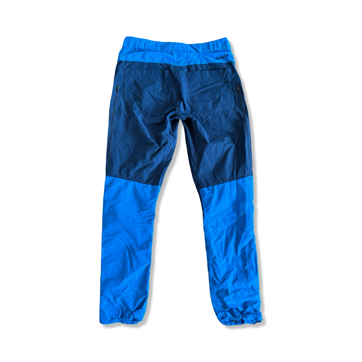 Men's Norröna Bitihorn hiking pants in two shades of blue, back view on a white background.