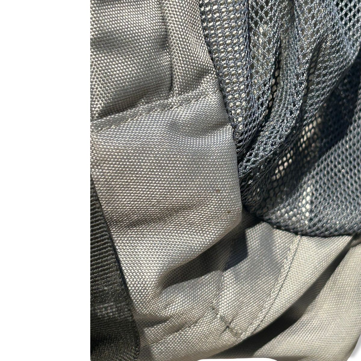 Close-up of the grey Deuter Futura 22L AC backpack fabric and mesh pocket showing a small stain.