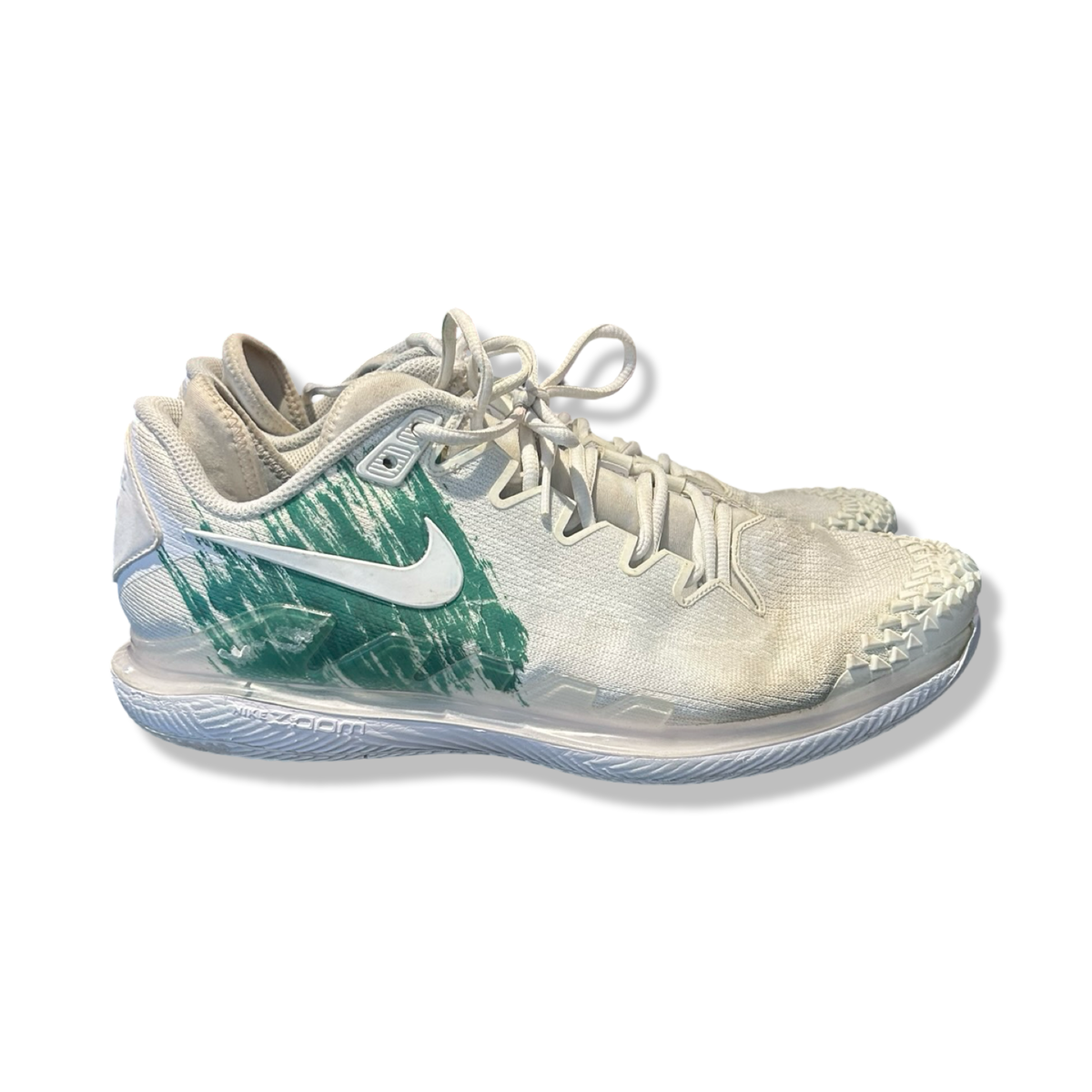 White and green Nike NikeCourt Air Zoom Vapor X Knit men's athletic shoes, side view against a white background.