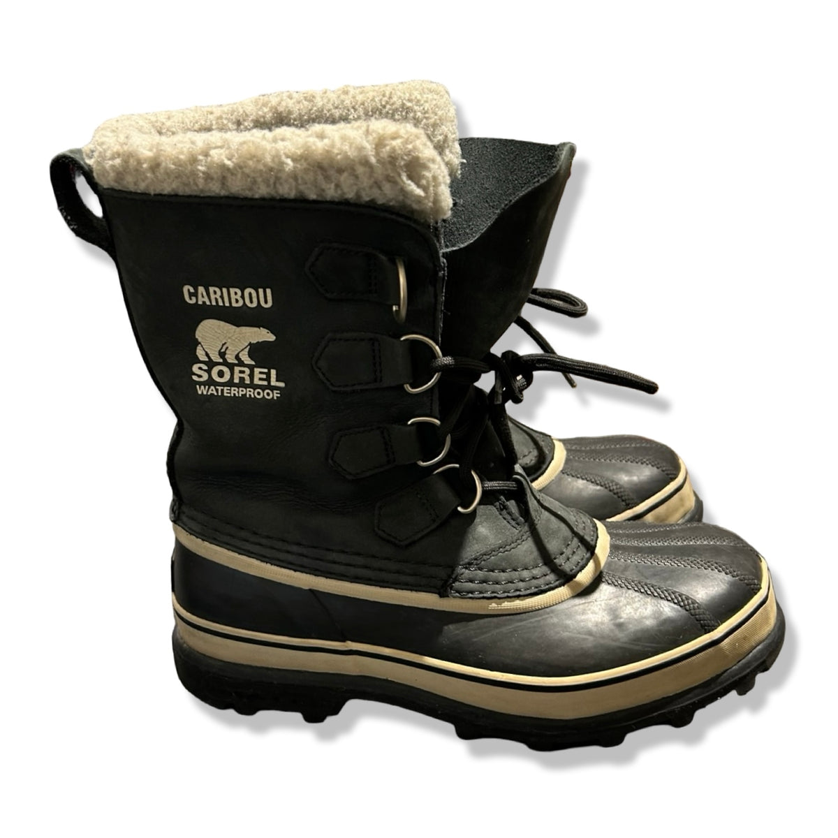 Dark green Sorel Caribou women's winter boots with wool lining, side view against a white background.