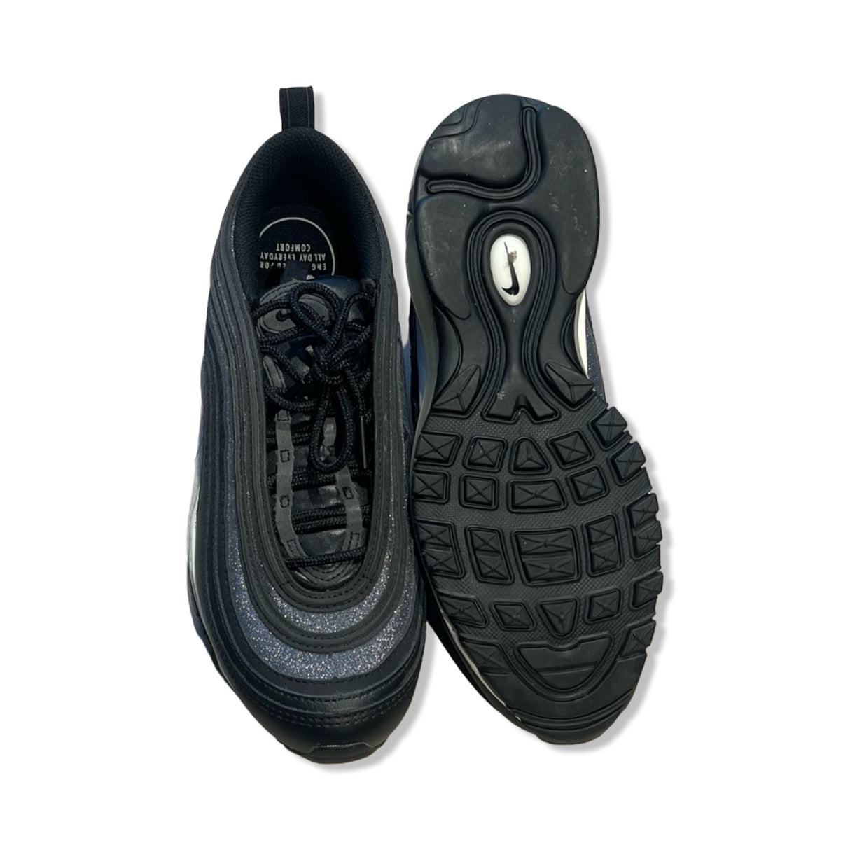 Women's Nike Air Max 97 sneakers in black and silver, featuring a top-down view and the textured rubber sole.