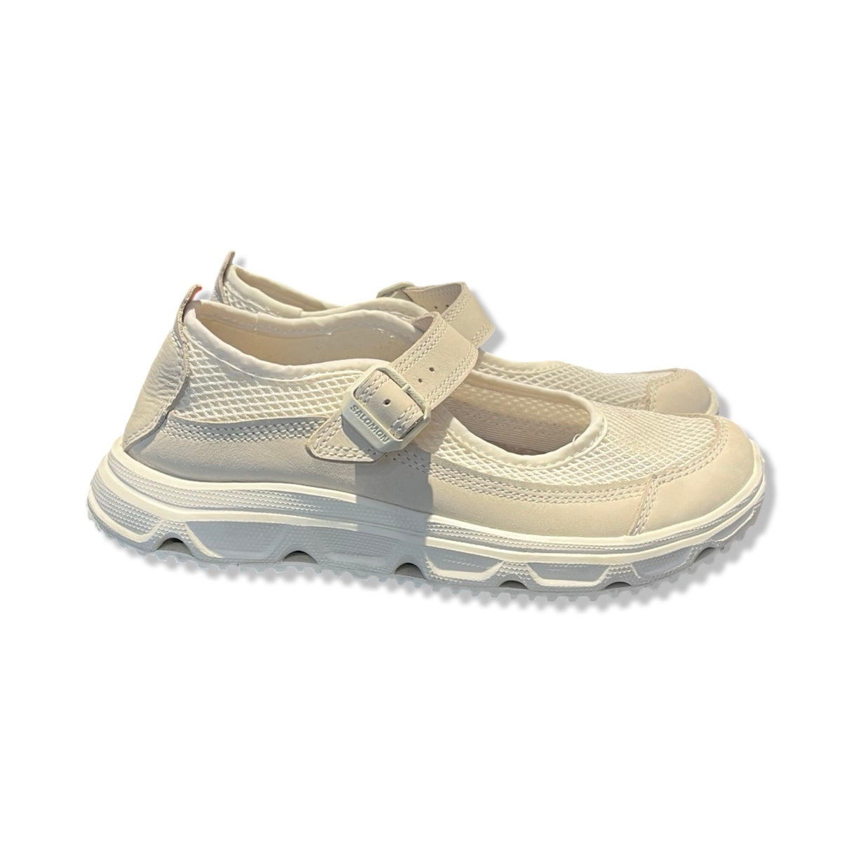 Salomon white sporty Mary Jane sneakers with buckle strap and mesh, side view against a white background.