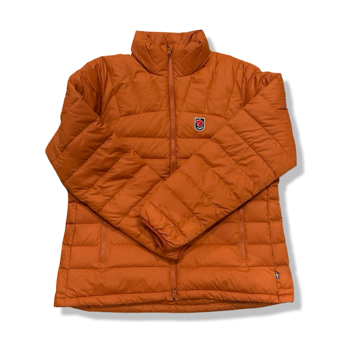 Orange Fjällräven women's Expedition Pack Down Jacket, front view against a white background.