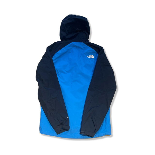 Men's blue shell jacket by The North Face with navy sleeves and hood, back view on a white background.