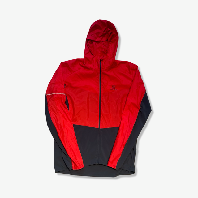 Men's red and black Salomon hooded training jacket, front view against a white background.