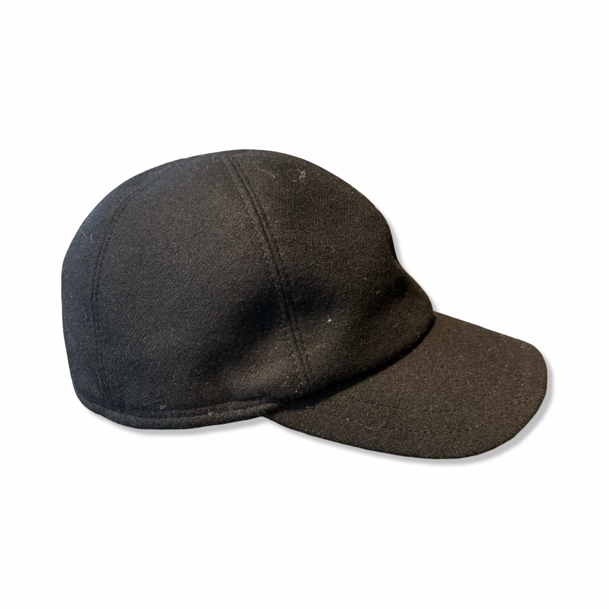 Black Monaco KG Göttmann wool-like baseball cap, side view against a white background.