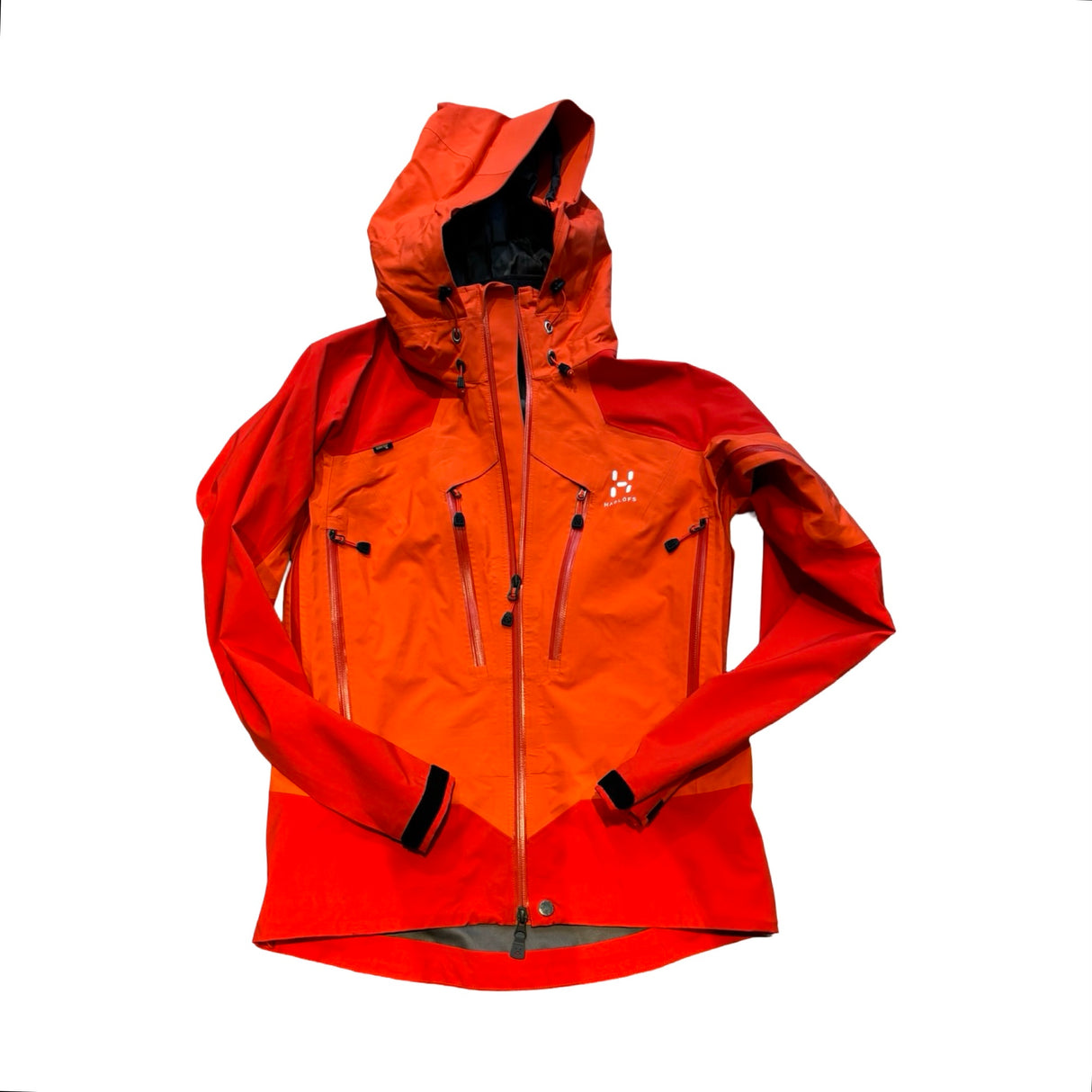Orange Haglöfs Spinx skaljacka i Gore-Tex för dam med huva, fotograferad platt mot en vit bakgrund.