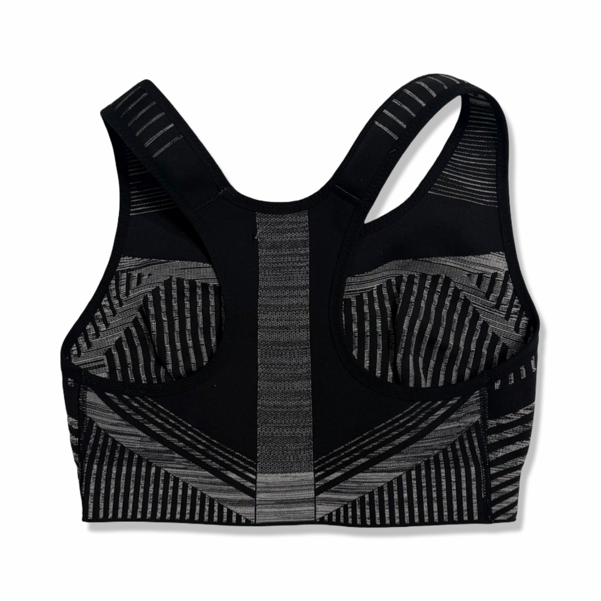 Baksidan av Nike Flyknit sport-BH för dam i svart och vitt, fotograferad mot en vit bakgrund.