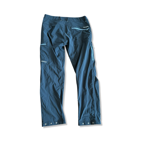 Men's Norröna Falketind hiking pants in black with light blue zippers, back view on a white background.