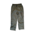 Green Fjällräven women's shell pants with elastic waistband and drawstring, front view against a white background.