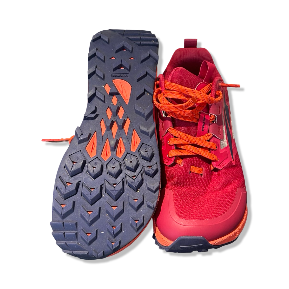 Pink Altra Lone Peak 7 women's hiking shoes focusing on the treaded outsole, displayed against a white background.