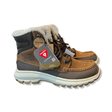 Brown Helly Hansen Garibaldi V3 men's winter boots with faux fur and lacing, photographed against a white background.