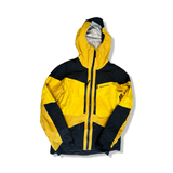 Yellow and black Peak Performance Gravity GORE-TEX 3L men's shell jacket, front view against a white background.