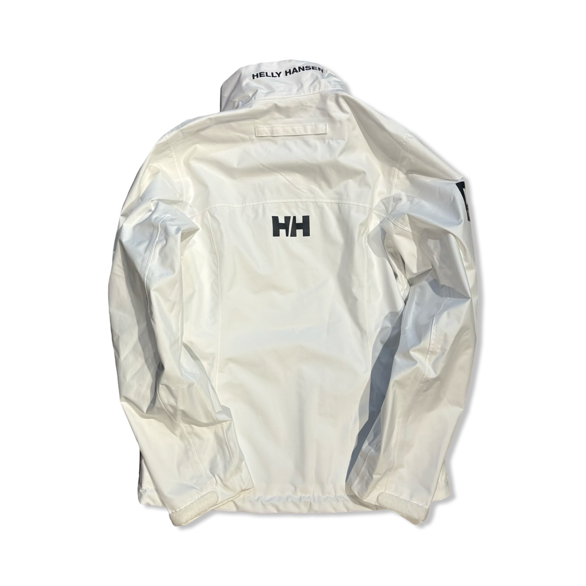 Back view of a white Helly Hansen women's Crew Sailing Jacket 2.0 against a white background.