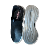 Black women's Skechers Ultra Flex 3.0 Smooth Step sneakers shown from above and with the sole visible.