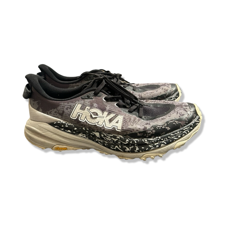 Black and patterned Hoka Speedgoat 6 men's running shoes, side view against a white background.