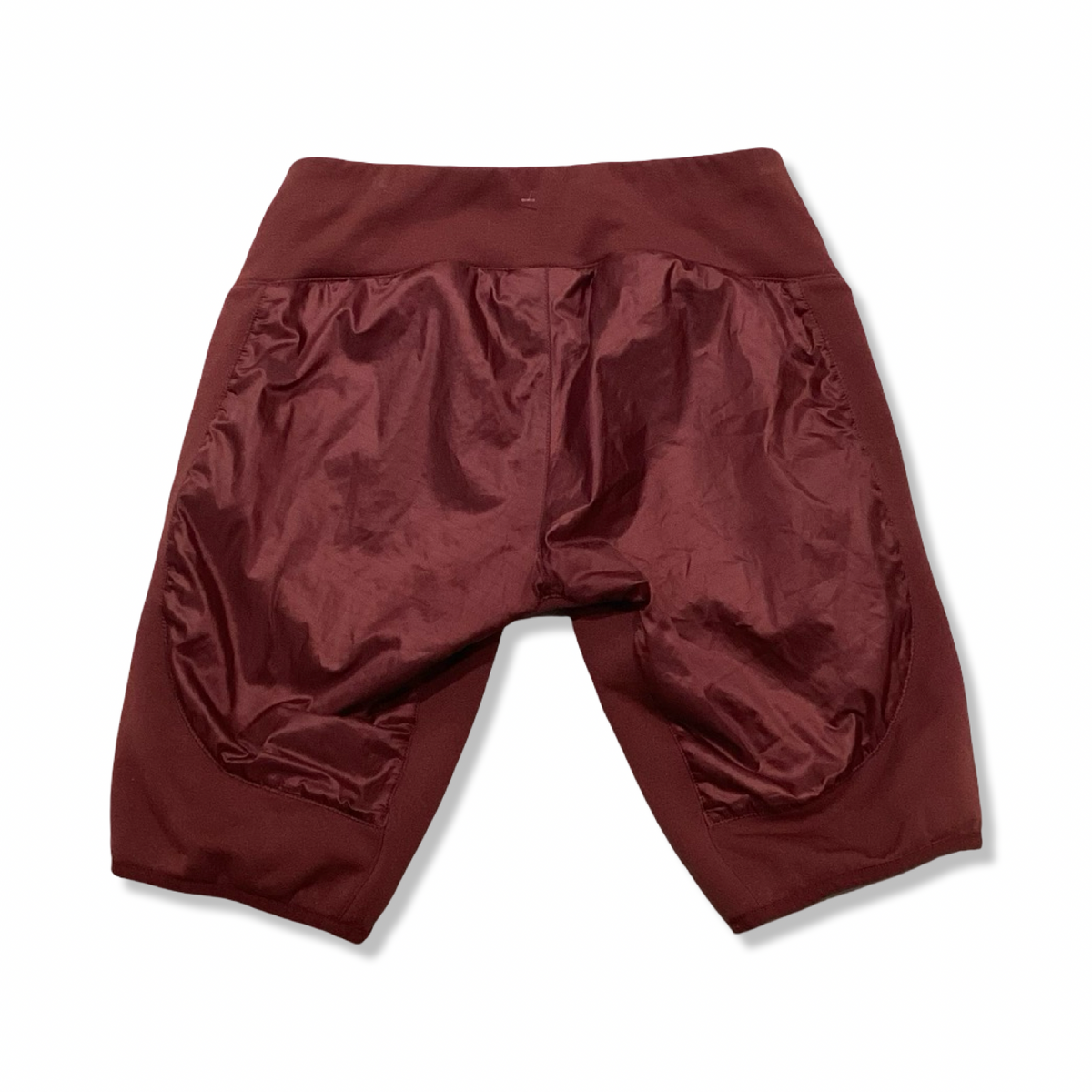 Back view of a rust-brown synthetic-lined women's base layer pants from Houdini against a white background.