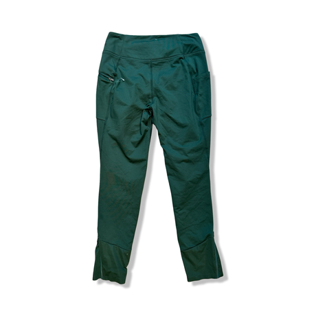 Green Outdoor Research women's training tights, back view against a white background.