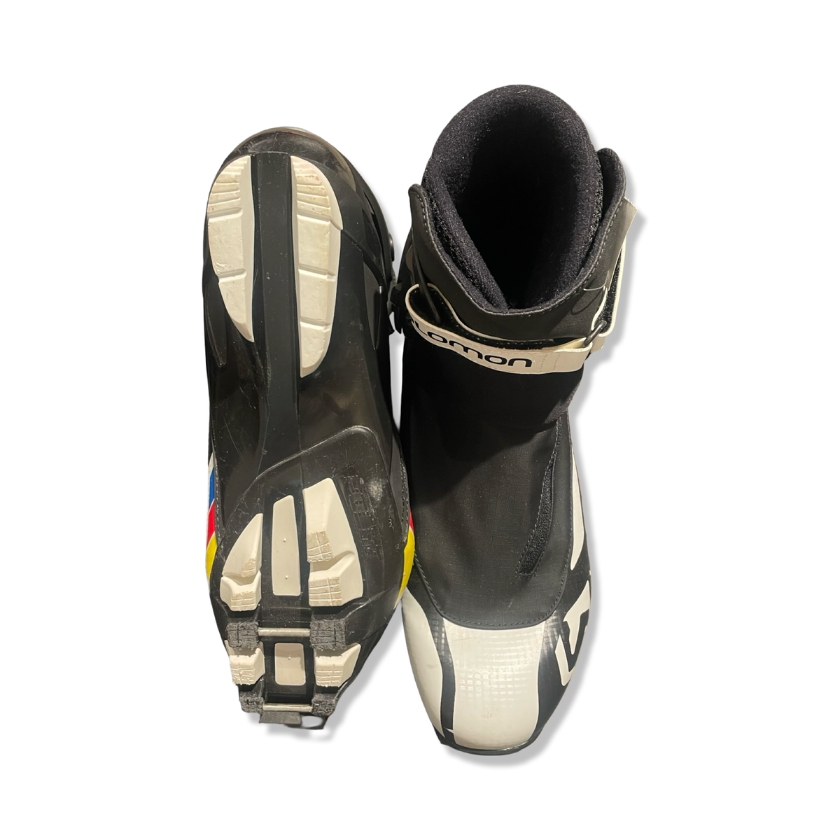 White and black Salomon men's pro combi boots, shown from above and below against a white background.