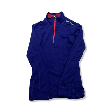 Blue Ortovox women's long sleeve base layer top with a zipper, front view against a white background.