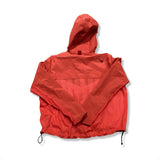 Back view of a red Nike women's training jacket with a hood, photographed against a white background.