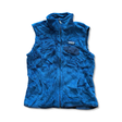 Blue Patagonia women's fleece vest with a zipper and chest pocket, front view against a white background.