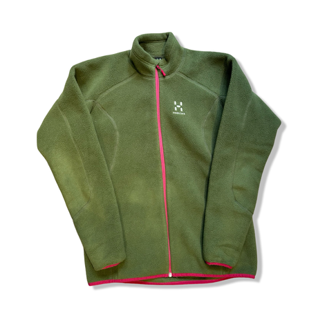 Green Haglbfs women's fleece jacket with a pink zipper, front view against a white background.