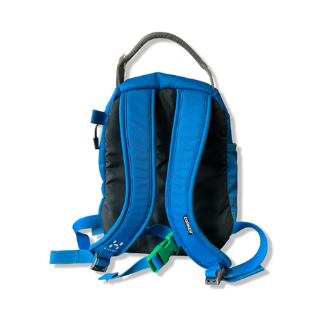 Blue and black Haglöfs Corker small backpack, back view showing shoulder straps against a white background.