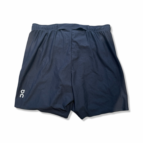 Back view of black ON men's Pace mesh athletic shorts against a white background.