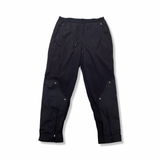 Black Nike women's training pants with zippers at the leg cuffs, front view against a white background.