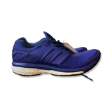 Blå Adidas Supernova Glide löparskor med vit sula för dam, fotograferade från sidan mot en vit bakgrund.