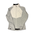 Grey Asics men's hybrid jacket with a quilted chest panel and zipper, front view against a white background.