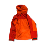 Women's orange and red Arc'teryx Alpha AR Gore-Tex Pro shell jacket, back view on a white background.
