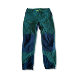 Men's green Haglöfs Rugged Mountain hiking pants with black reinforcements on a white background.