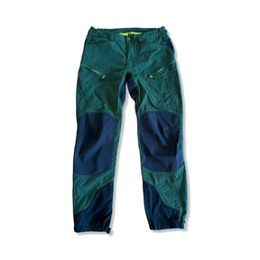 Men's green Haglöfs Rugged Mountain hiking pants with black reinforcements on a white background.