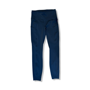 Blå träningstights med fickor från Lululemon för dam, fotograferade framifrån mot en vit bakgrund.