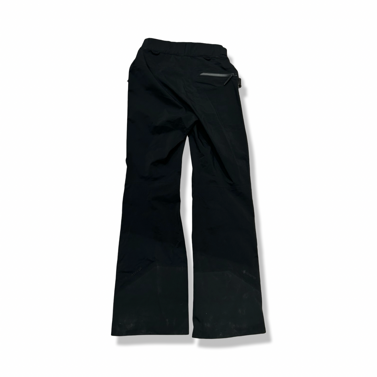 Black Peak Performance women's Alpine Gore-Tex shell pants, back view against a white background.